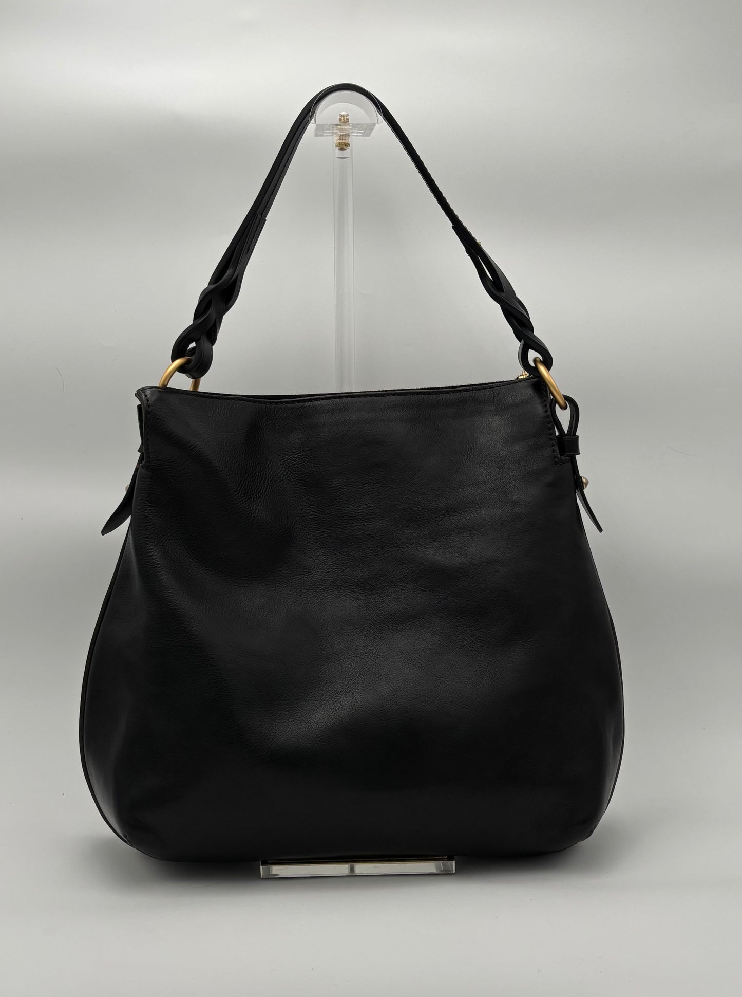 Black handbag on a gray background