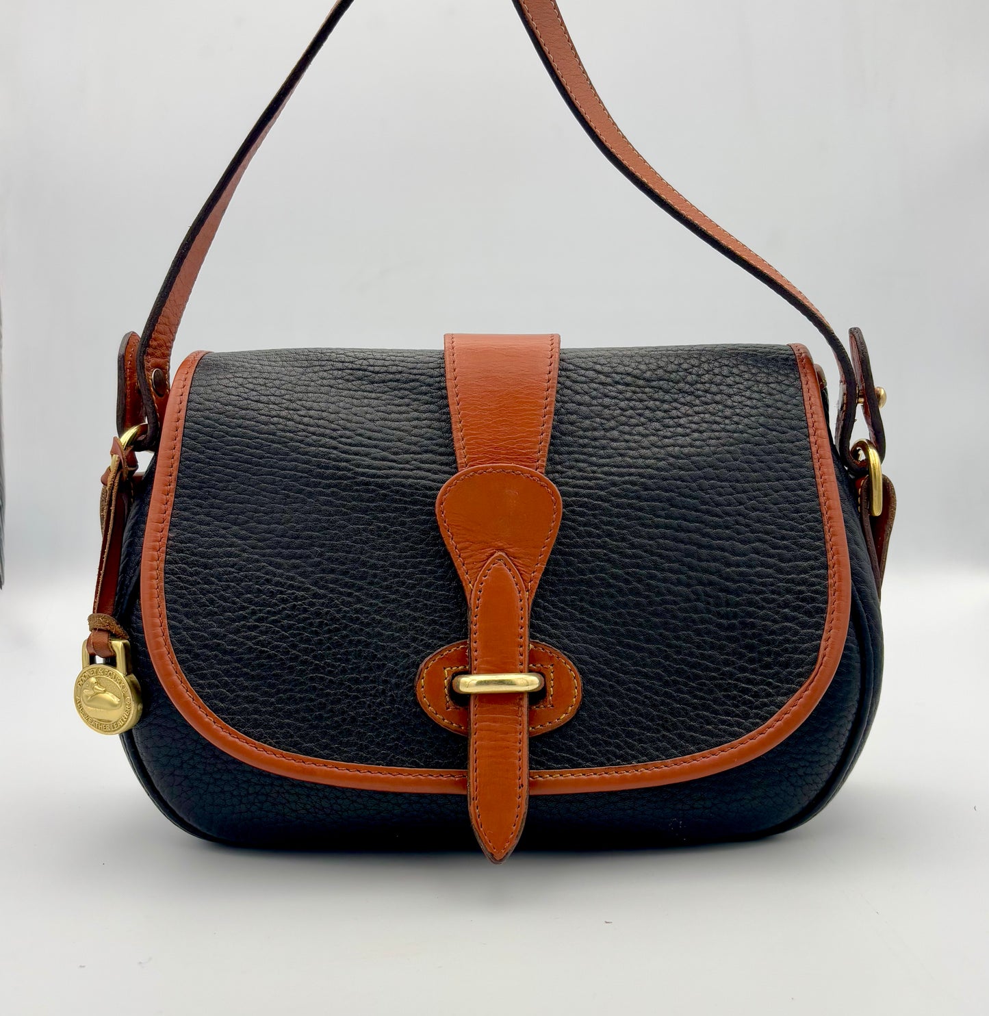 Authenticated Vintage Dooney & Bourke All Weather Leather Black/Tan Small Tack Saddlebag Crossbody