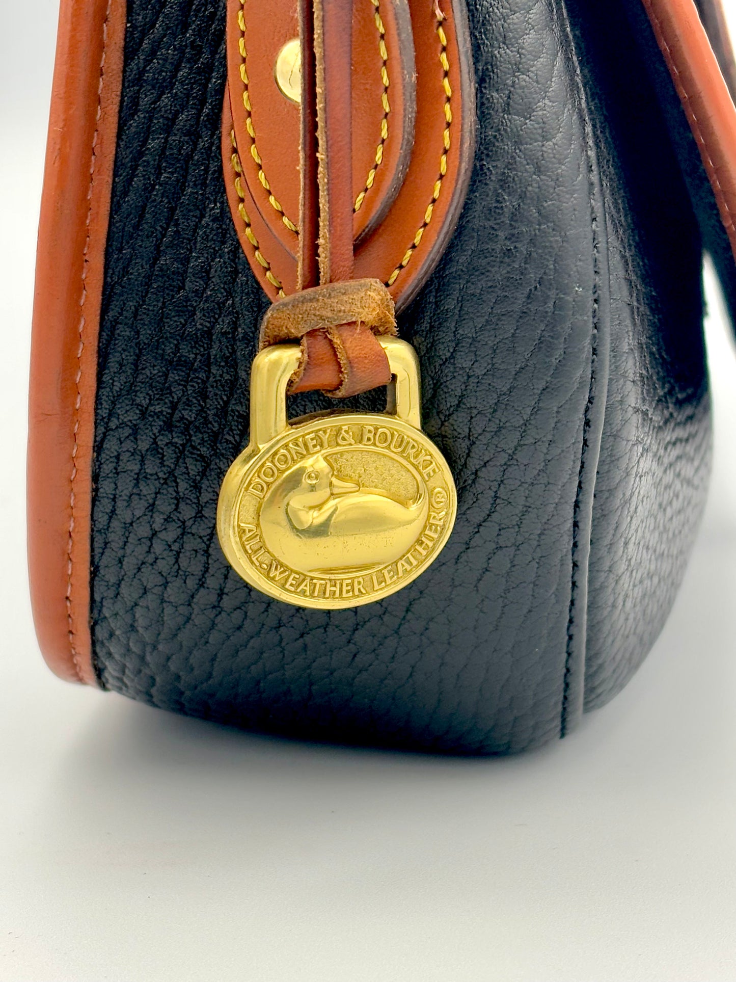 Authenticated Vintage Dooney & Bourke All Weather Leather Black/Tan Small Tack Saddlebag Crossbody